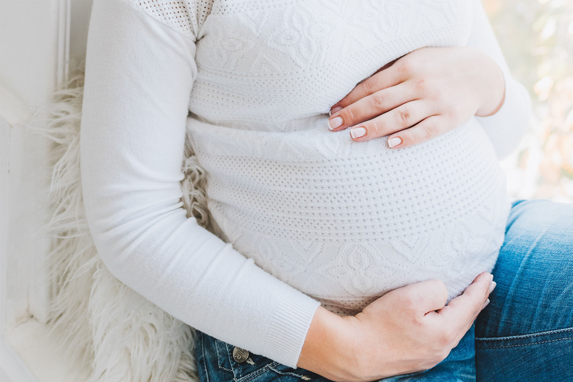 Pregnant woman holding her stomach