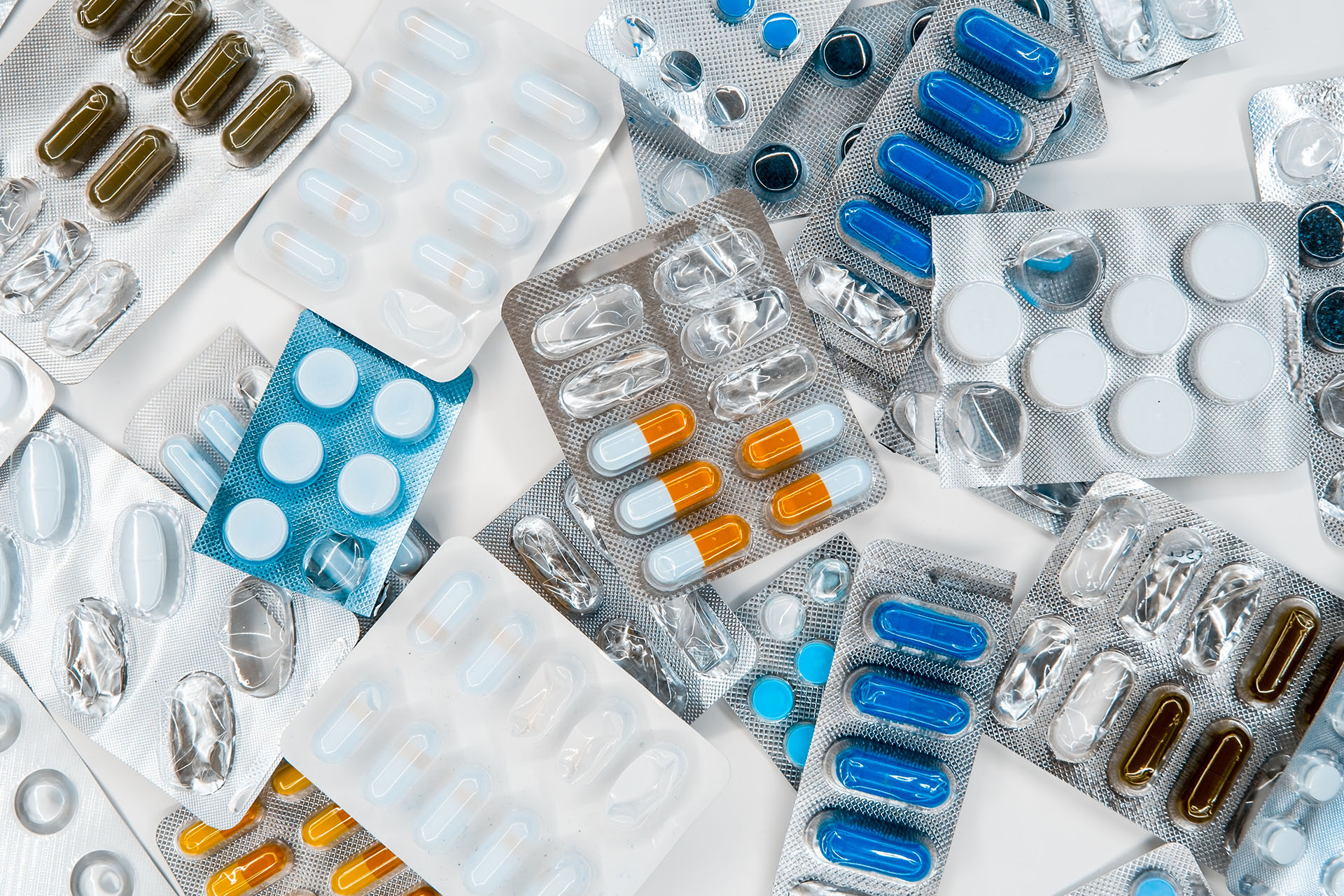 Large pile of various medications on white background